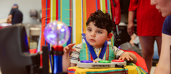Young boy in a Geeks for Kids car